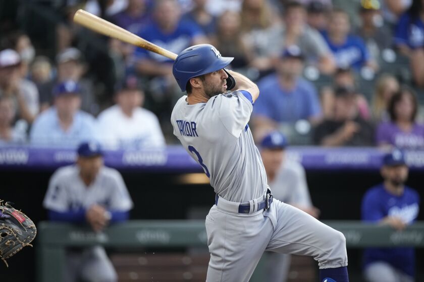 Los Angeles Dodgers' Chris Taylor follows through on a three-run home run off Colorado Rockies starting pitcher Chi Chi Gonzalez during the first inning of a baseball game Friday, July 16, 2021, in Denver. (AP Photo/David Zalubowski)