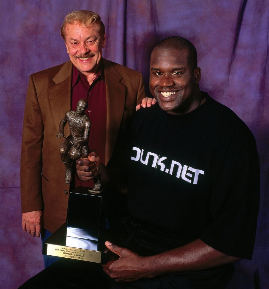 After winning the NBA Most Valuable Player award, Shaquille O'Neal poses with Lakers owner Jerry Buss at Staples Center in Los Angeles.