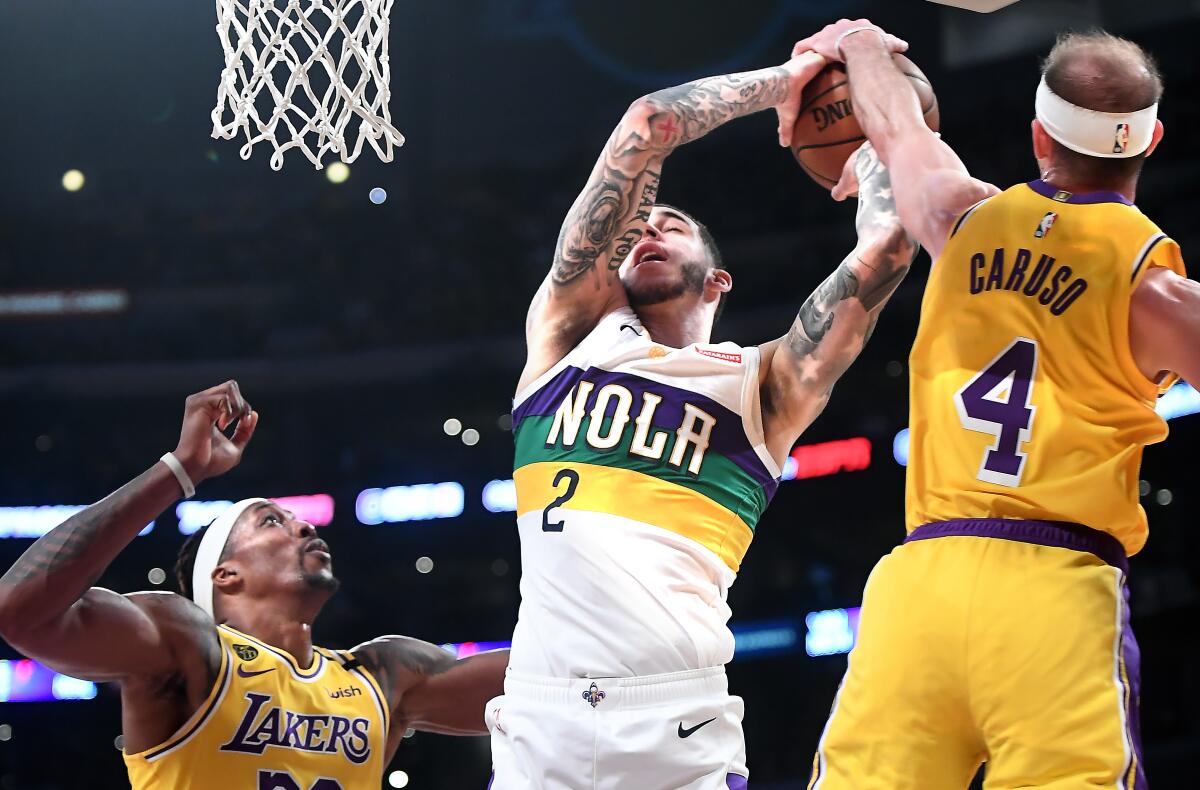 Lakers guard Alex Caruso blocks a shot by Pelicans guard Lonzo Ball during the fourth quarter of a game Feb. 25, 2020, at Staples Center.