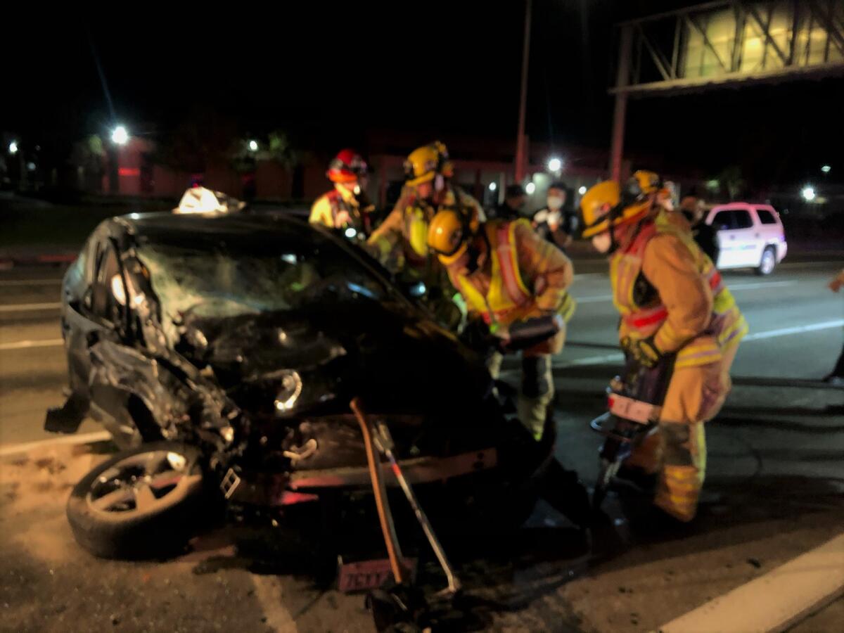 Firefighters use the jaws of life Saturday to extricate a man from his vehicle near Harbor Boulevard and South Coast Drive.