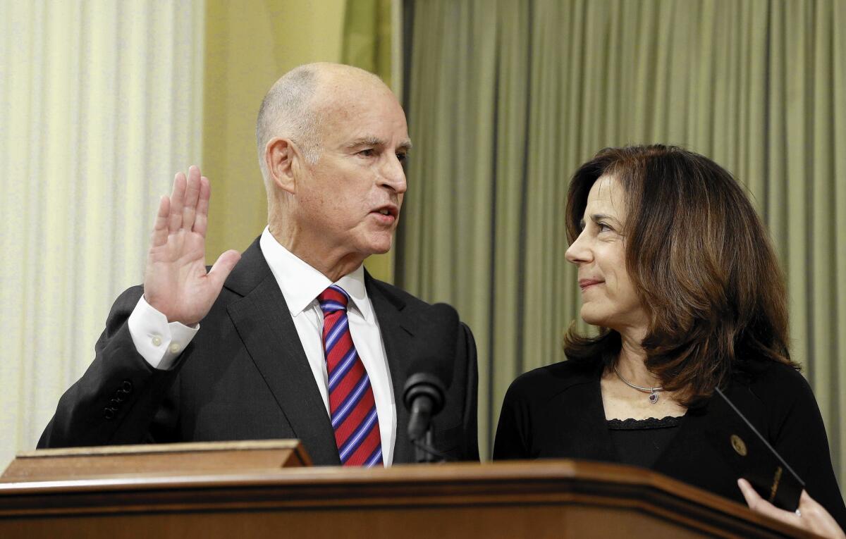 Gov. Jerry Brown takes the oath of office with his wife, Anne Gust Brown, at his side on Jan. 5.