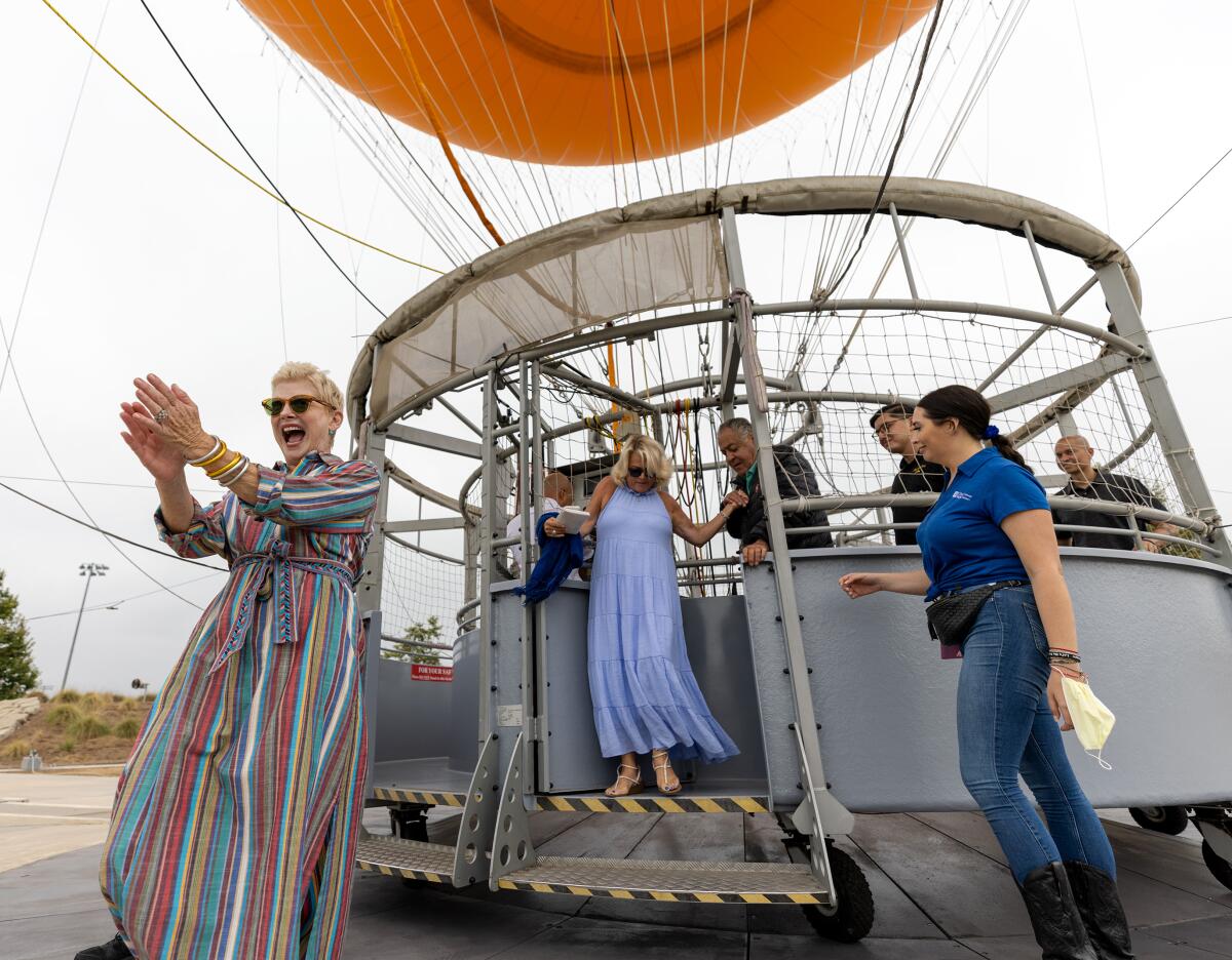 Donna McNutt, resident of Laguna Beach, celebrates with City of Hope as she steps off of the Great Park Balloon in Irvine.