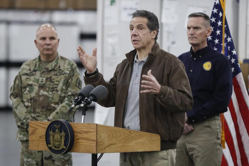 New York Gov. Andrew Cuomo speaks during a news conference alongside the National Guard at the Jacob Javits Center that will house a temporary hospital in response to the COVID-19 outbreak, Monday, March 23, 2020, in New York. New York City hospitals are just 10 days from running out of "really basic supplies," Mayor Bill de Blasio said late Sunday. De Blasio has called upon the federal government to boost the city's quickly dwindling supply of protective equipment. The city also faces a potentially deadly dearth of ventilators to treat those infected by the coronavirus. (AP Photo/John Minchillo)