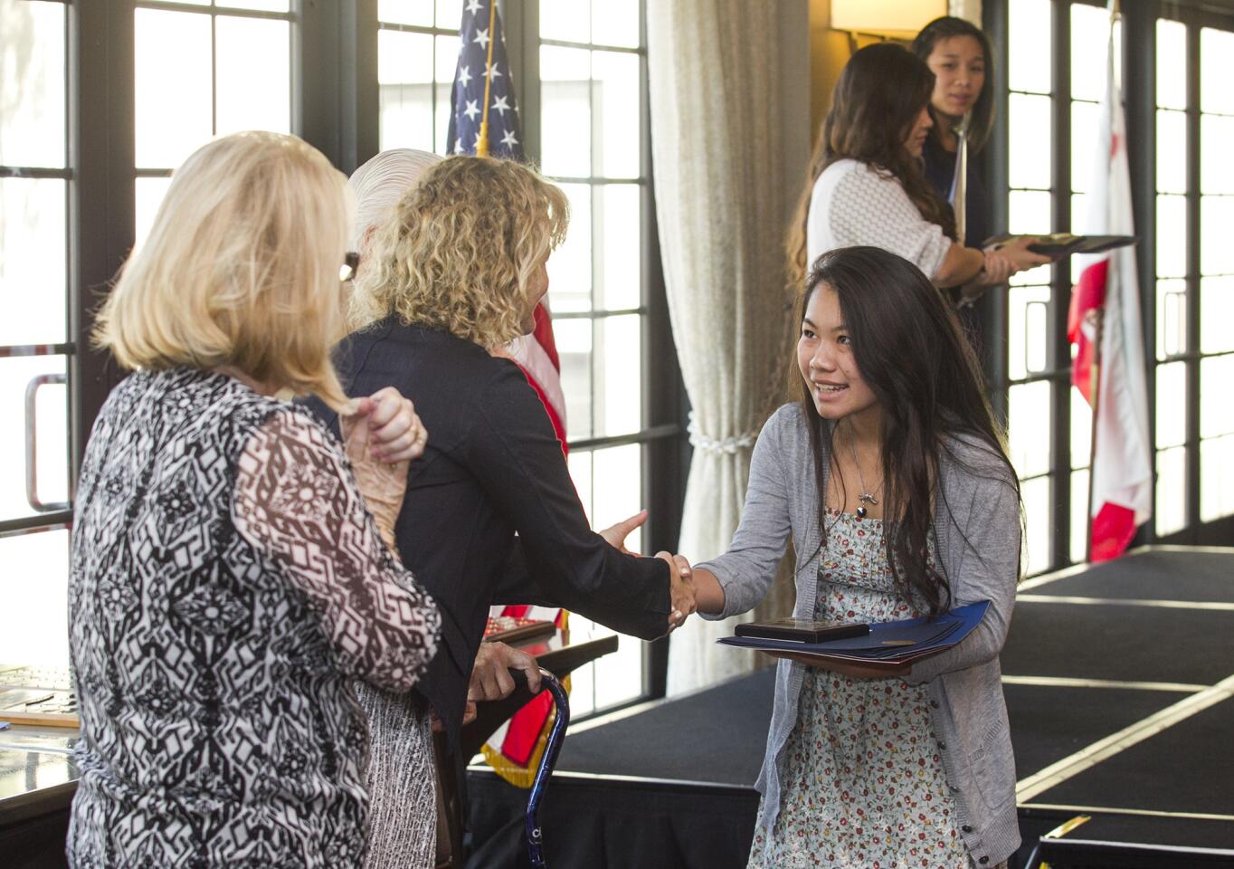 Costa Mesa High School's Hoan Nguyen shakes hands with Katrina Foley during the 35th annual Scholarship Recognition Breakfast, hosted by the Costa Mesa Chamber of Commerce on Friday, May 16. Nguyen received the Les Miller Outstanding Student Award. (Scott Smeltzer - Daily Pilot)
