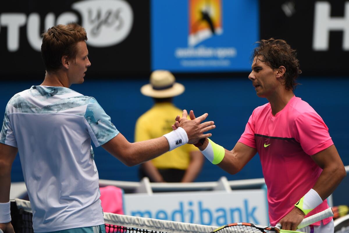 Tomas Berdych shakes hands with Rafael Nadal after defeating him in the Australian Open in Melbourne.