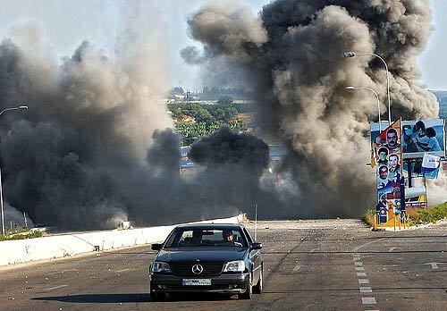 Smoke rises from an Israeli air raid Wednesday in the Zahrani region on the Mediterranean coast of southern Lebanon. Israeli troops sent warplanes, gunboats and ground troops into the area after Hezbollah fighters launched a raid into Israel and captured two Israeli soldiers.