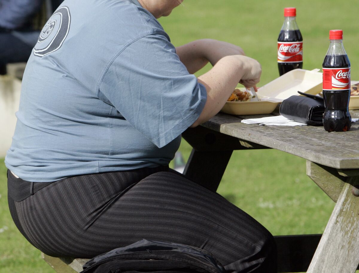 FILE - A person eats in London on Oct. 17, 2007. The World Health Organization says the number of heavy people in Europe has hit “epidemic proportions,” with nearly 60% of adults and one third of children weighing in as either overweight or obese. In a report issued on Tuesday, the U.N. health agency’s European office said the prevalence of obesity among adults is higher across the continent than any other world region, except for the Americas. (AP Photo/Kirsty Wigglesworth, File)