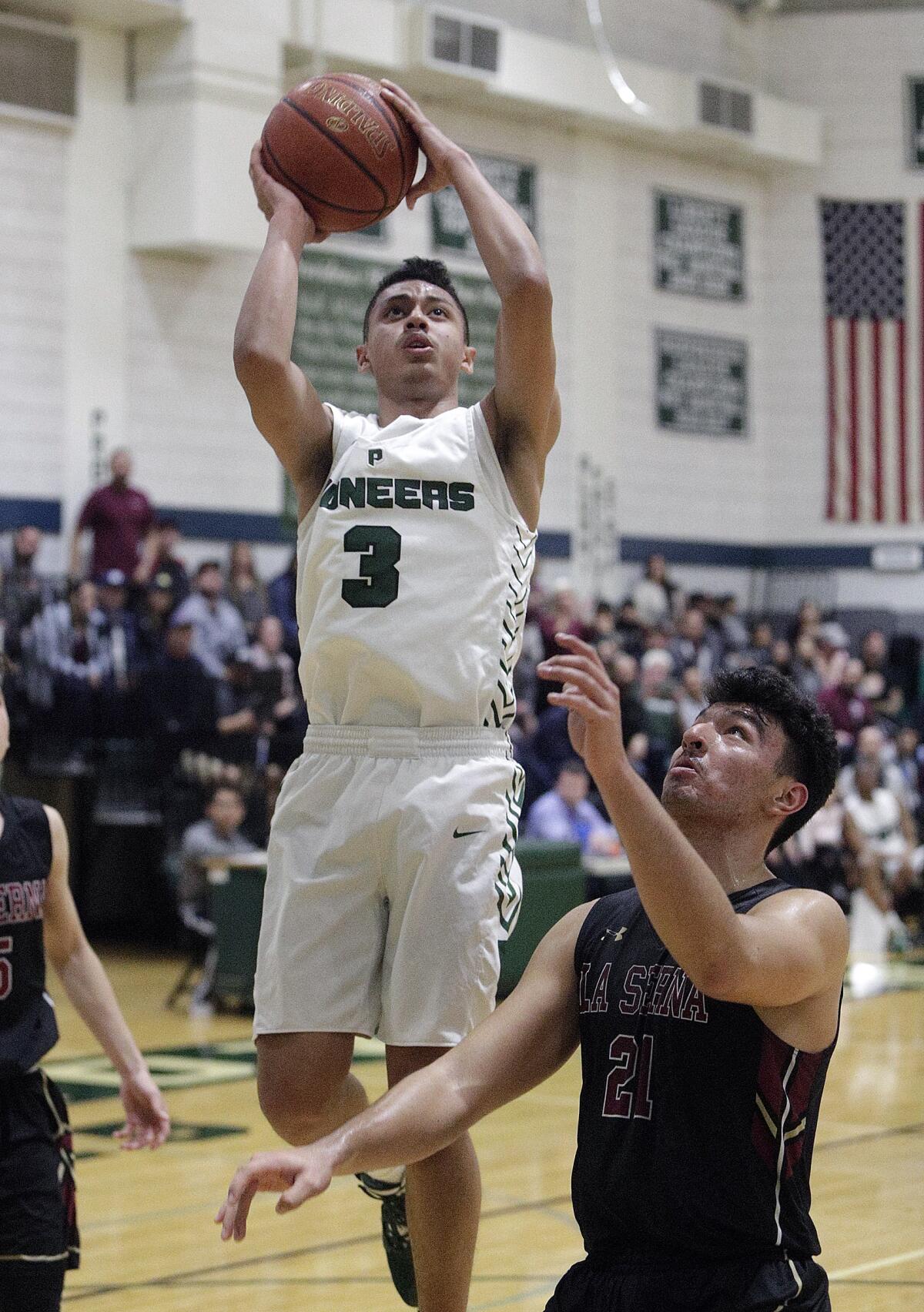 Providence's Bryce Whitaker shoots against La Serna's Jacob Leija in the CIF Southern Section Division III-AA quarterfinal boys' basketball playoff at Providence High School on Tuesday, February 18, 2020.