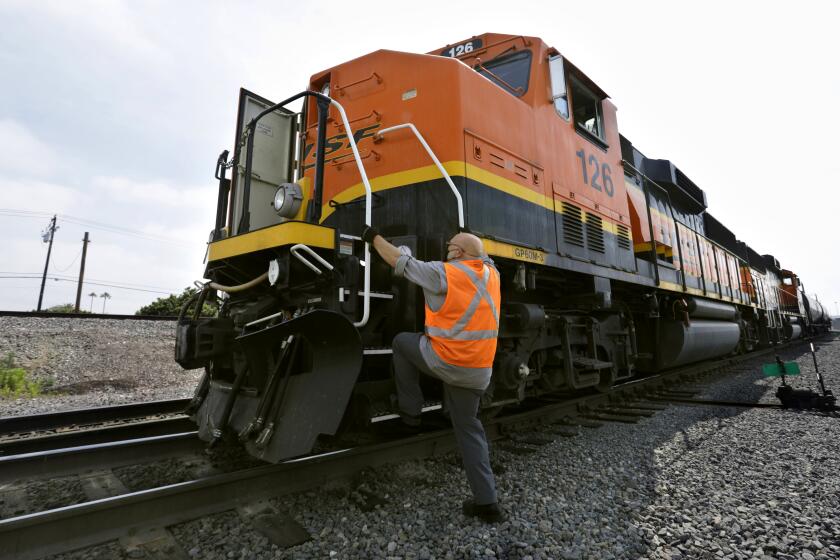 LA MIRADA, CA-MAY 8, 2020-Russ Abbott, a locomotive engineer, drives the 3800 horsepower BNSF locomotive at the transit hub for the BNSF (Burlington Northern Santa Fe Railway) in La Mirada, CA. (Carolyn Cole/Los Angeles Times)