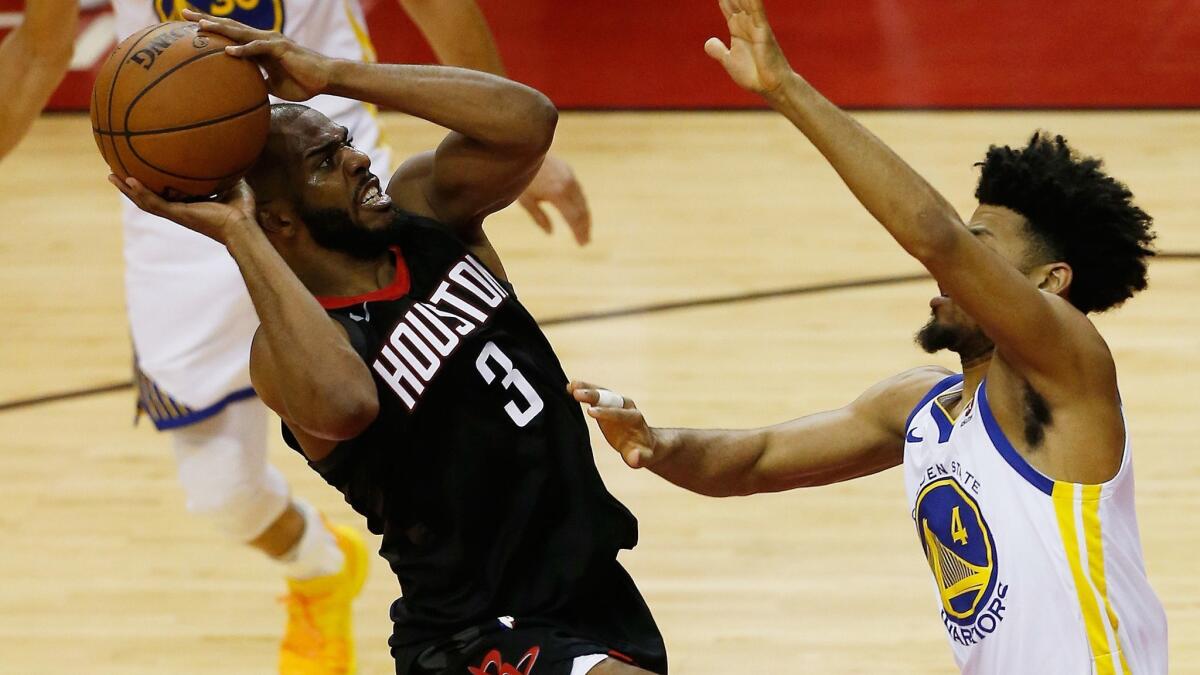 Rockets guard Chris Paul attempts an off-balance shot over Warriors guard Quinn Cook during the fourth quarter of Game 5 on Thursday.