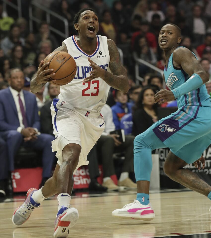 LOS ANGELES, CA, MONDAY, OCTOBER 28, 2019 - LA Clippers guard Lou Williams (23) dives past Charlotte Hornets guard Terry Rozier (3) during second half action at Staples Center.(Robert Gauthier/Los Angeles Times)