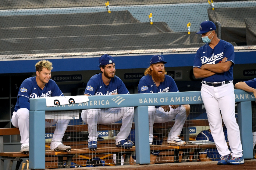 Dodgers teammates Joc Pederson, Cody Bellinger, Justin Turner talk to bench coach Bob Geren.