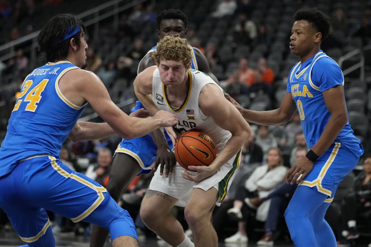 Baylor's Caleb Lohner battles for the ball with UCLA's Jaime Jaquez Jr. and Jaylen Clark.