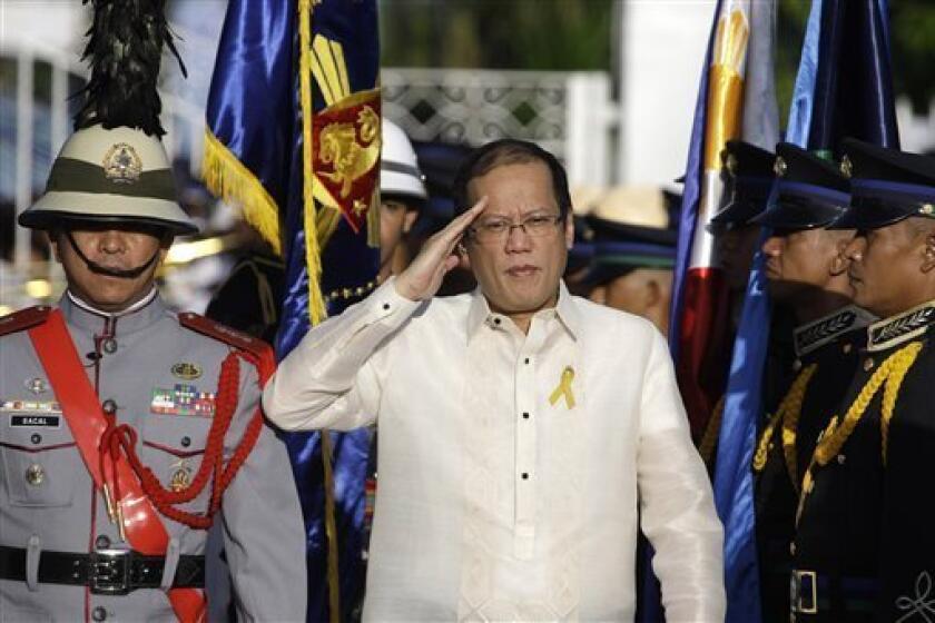 Philippines President Benigno Aquino salutes during arrival honors at the historic Emilio Aguinaldo Shrine in Kawit, Cavite province, south of Manila, Philippines during the 113th Philippine Independence Day celebrations Sunday, June 12, 2011. The shrine was where Philippine independence from Spain was proclaimed on June 12, 1898.(AP Photo/Aaron Favila)