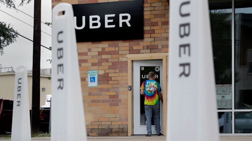 A person in a "Keep Austin weird" shirt enters the Uber offices in Texas' capital on Friday.