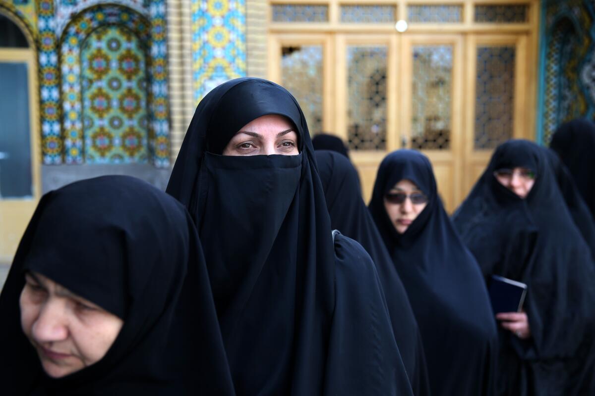 Iranian women stand in line at a polling station during the parliamentary elections in Qom, south of Tehran, on Feb. 26, 2016.