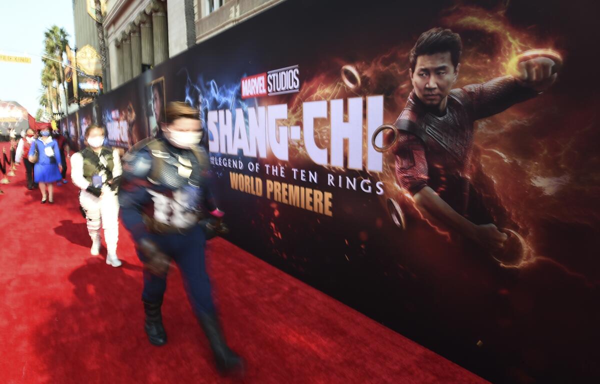 Fans dressed as Marvel characters attend the premiere of "Shang-Chi and the Legend of the Ten Rings" on Monday, Aug. 16, 2021, at the El Capitan Theatre in Los Angeles. (Photo by Jordan Strauss/Invision/AP)
