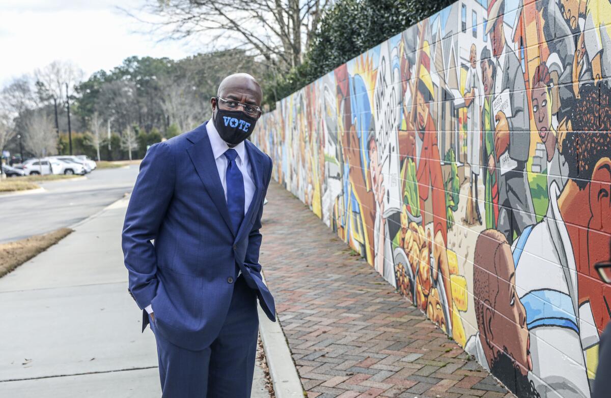 The Rev. Raphael Warnock at a mural honoring a civil rights pioneer in Marietta, Ga.