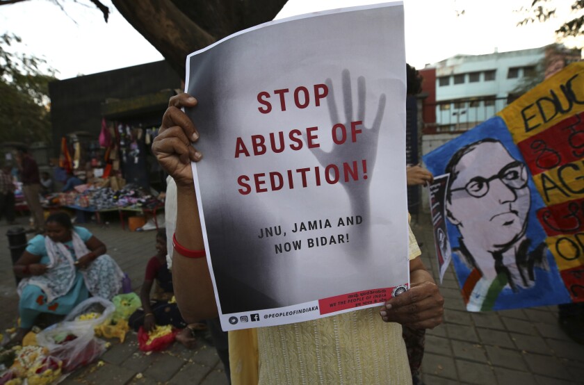 A woman holds a placard protesting against the sedition case filed by police against a school after a play performed by students denouncing a new citizenship law, in Bangalore, India, Tuesday, Feb. 4, 2020. India's Supreme Court on Wednesday, May 11, 2022, put the country's colonial-era sedition law on hold, asking the Indian government and state authorities to refrain from registering fresh cases under the harsh law while it was under review. Critics say the government under Prime Minister Narendra Modi was increasingly using it to silence criticism and dissent. (AP Photo/Aijaz Rahi, File)