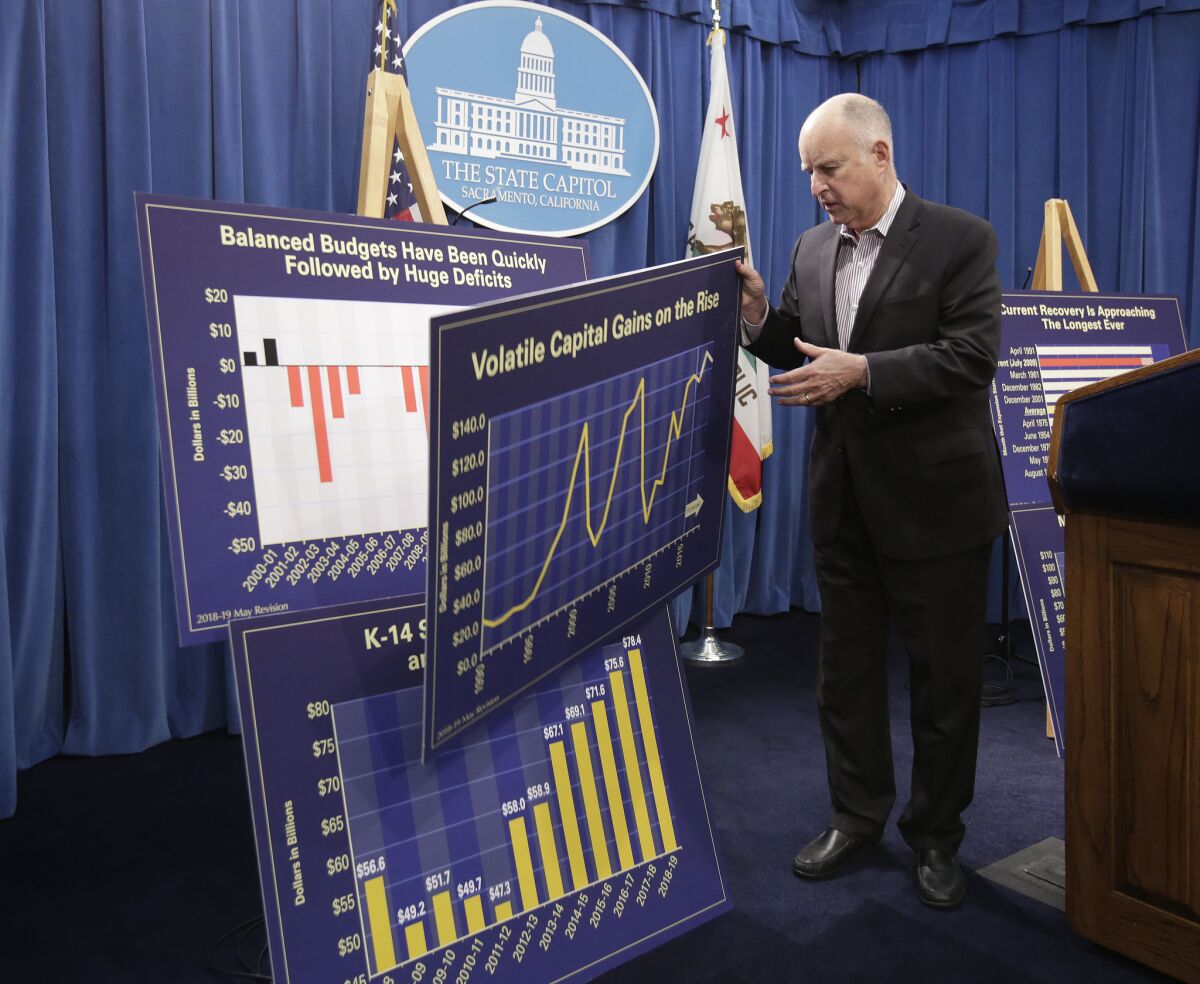 Gov. Jerry Brown discusses his revised 2018-19 state budget at a Capitol news conference Friday in Sacramento.