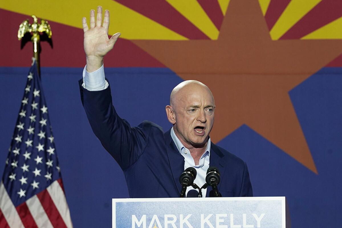 Democratic Sen. Mark Kelly of Arizona waves.