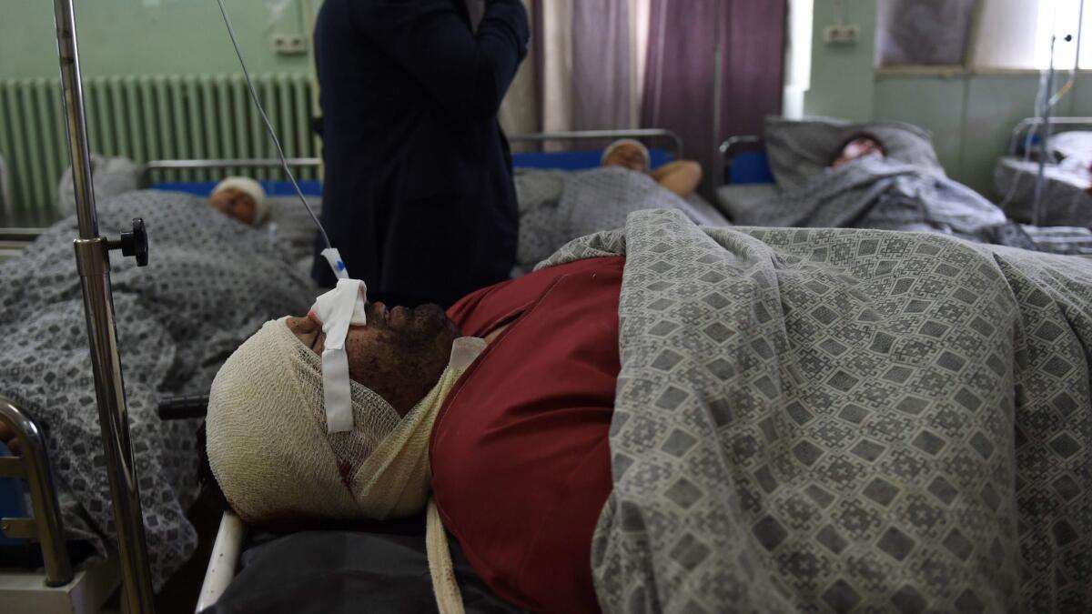 An Afghan victim injured in a suicide bomb attack lies in a ward at the Wazir Akbar Khan Hospital in Kabul on May 3.