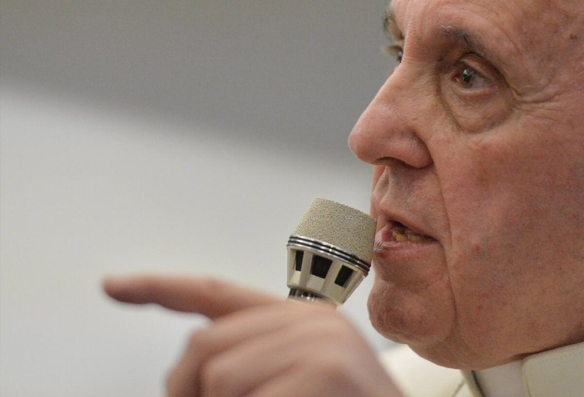 Pope Francis speaks during a news conference held aboard the papal flight from Rio de Janeiro to Italy.