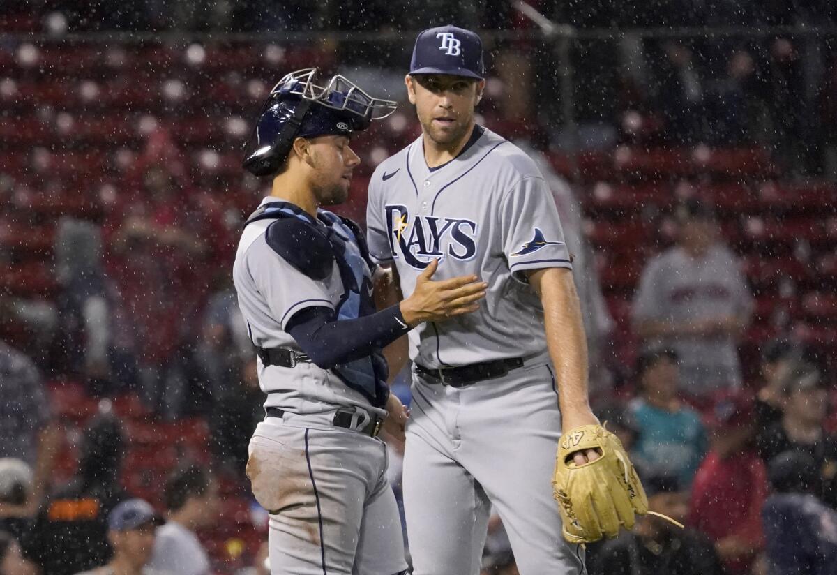 Tampa Bay Rays closer Jason Adam, right is congratulated by catcher Rene Pinto after the team's win over th Boston Red Sox in a baseball game at Fenway Park, Tuesday, July 5, 2022, in Boston. (AP Photo/Mary Schwalm)