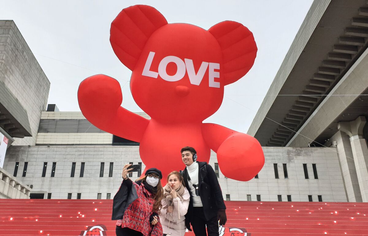 Tourists take a selfie in front of an 8-meter-tall installation by South Korean pop artist Im Ji-bin, which was set up ahead of Christmas in lieu of a tree in downtown Seoul.