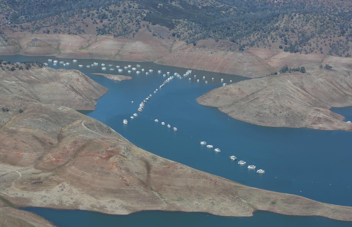 The receding waters of Lake McClure in Mariposa County can be seen. In a drastic action, California water officials on Friday ordered cuts in water diversions for some pre-1914 rights holders.