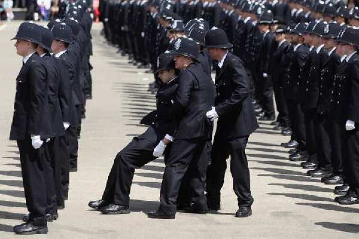 A British policeman faints during a parade. Tendency to faint is partly rooted in genetics, a study suggests.