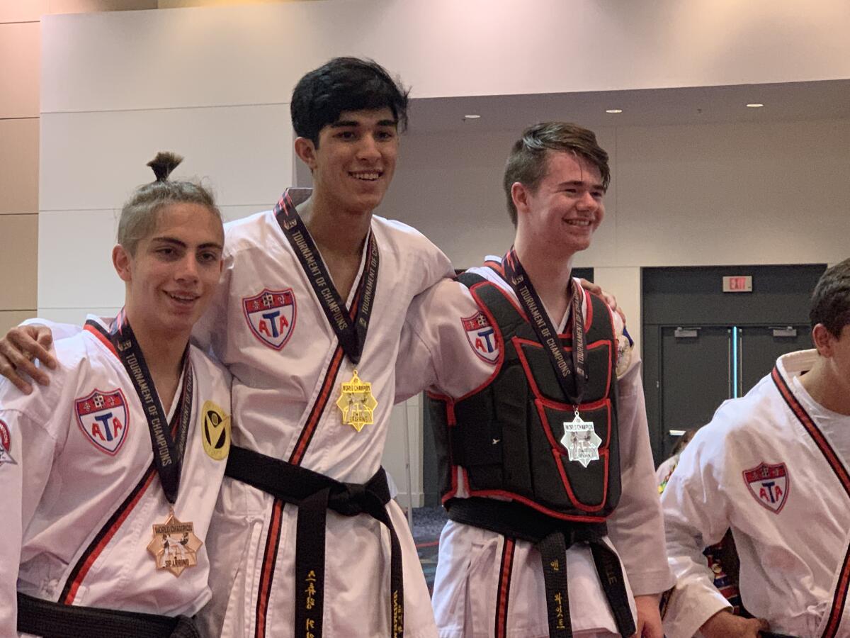 Andrew Heiati, center, won his second sparring gold medal at the ATA World Championships.