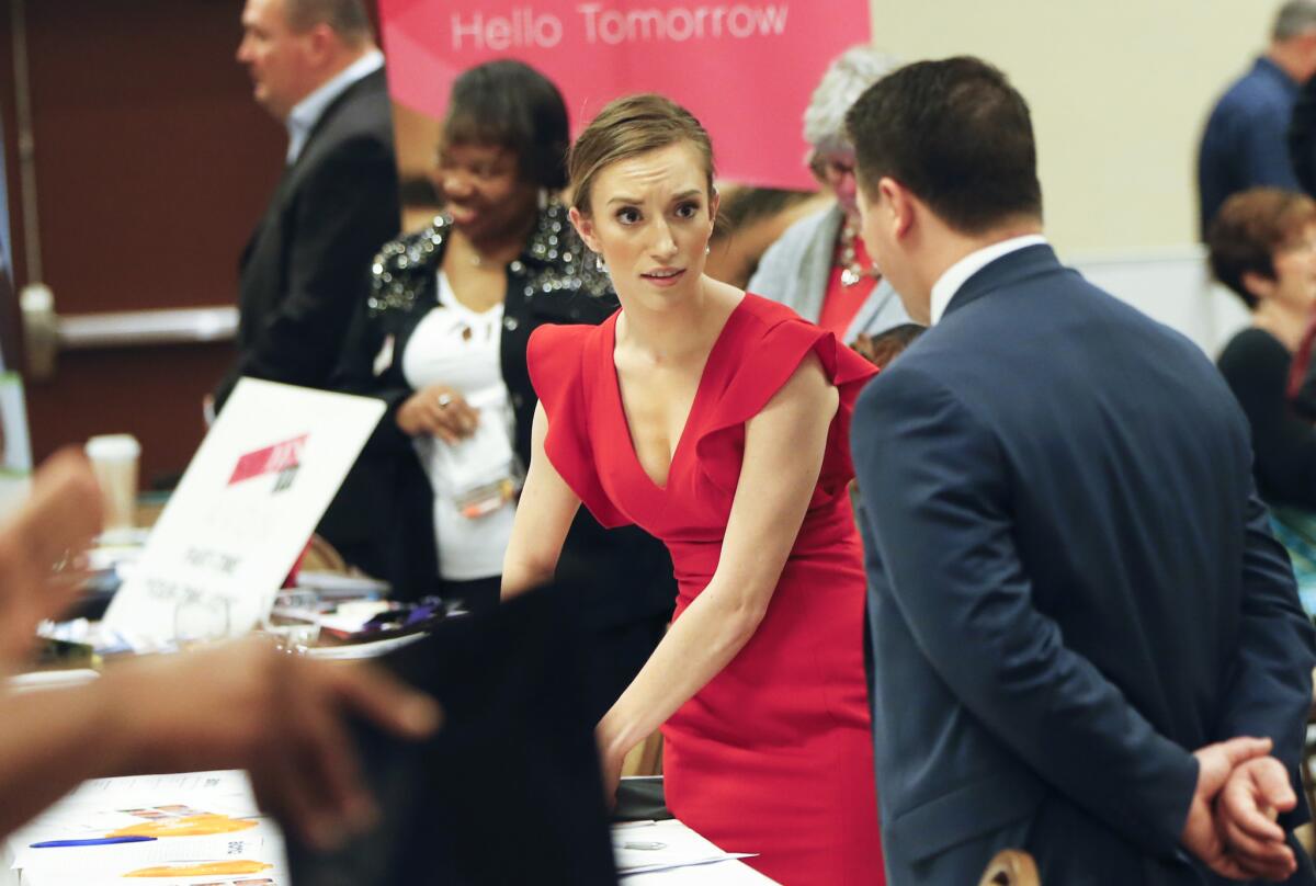 Recruiters work their booths at a job fair in Pittsburgh on March 30.