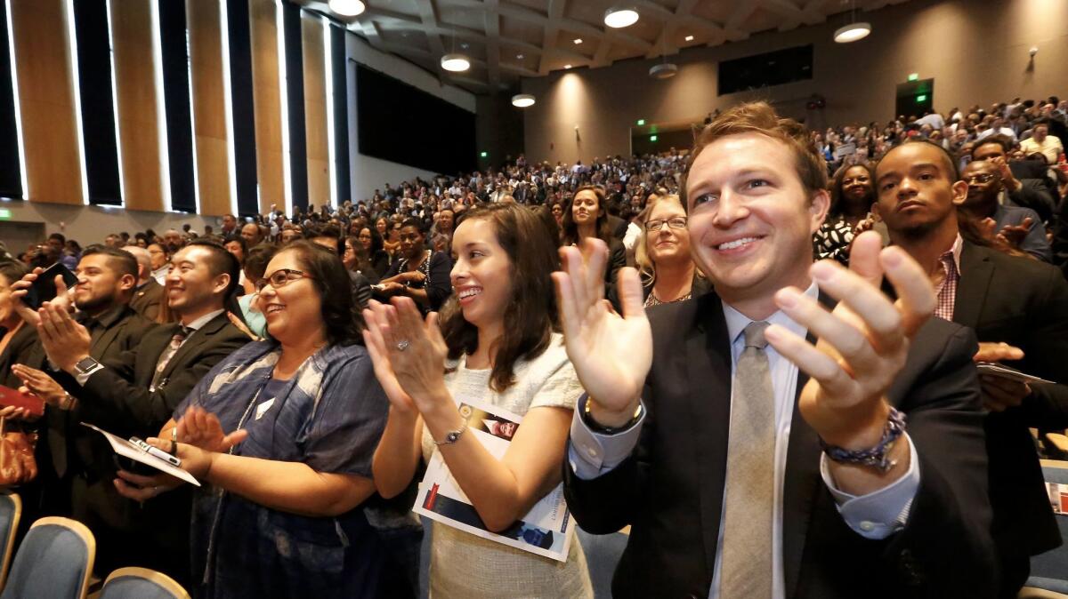 LAUSD School Board member Monica Garcia, incoming board members Kelly Gonez, and Nick Melvoin, left to right, applaude at the conclusion of Dr. Michelle King's Superintendent of Schools address.