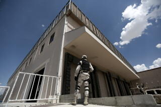 A soldier stands outside a newly opened migrant shelter, formerly an assembly plant, in Ciudad Juarez, Mexico
