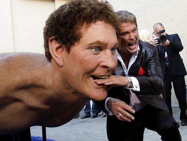 What's it like to be both honored and bashed in front of a TV audience? To find out, we followed former "Baywatch" star David Hasselhoff at the taping of "The Comedy Central Roast of David Hasselhoff." Here, the Hoff has fun with a larger-than-life statue of himself on a surfboard before his roast at Sony Studios.