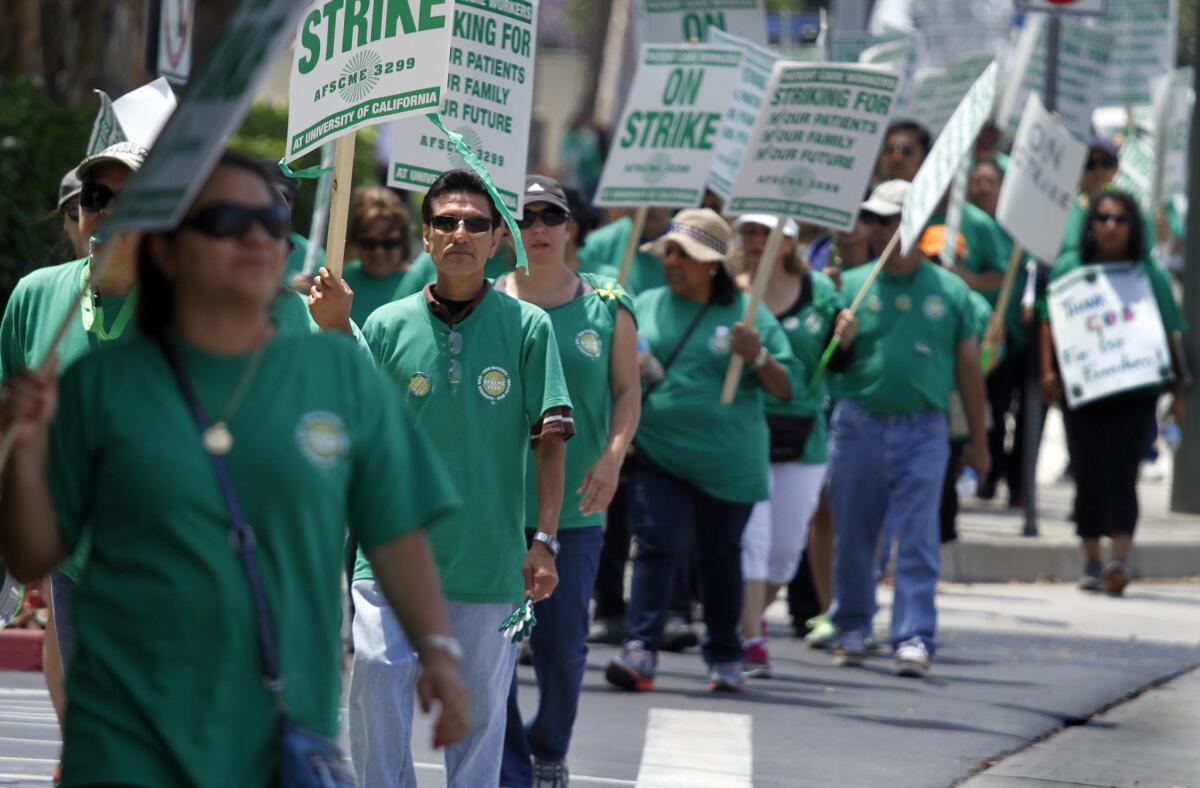 Unionized workers picket at UC Irvine Medical Center in May. The union has scheduled a five-day walkout starting March 3.