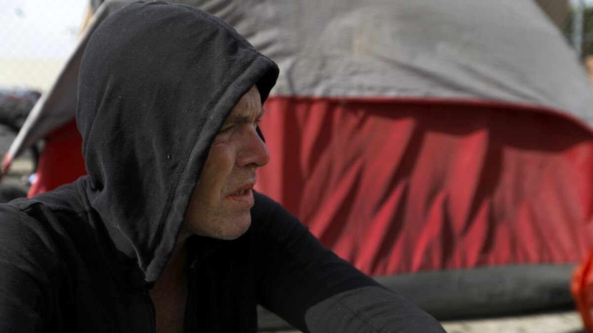 Adam Starr, a veteran of the first Gulf War, sits at his skid row camp site in 2018. Some property owners and shelter residents want to block a legal settlement that restricted the city's efforts to clear the encampments.