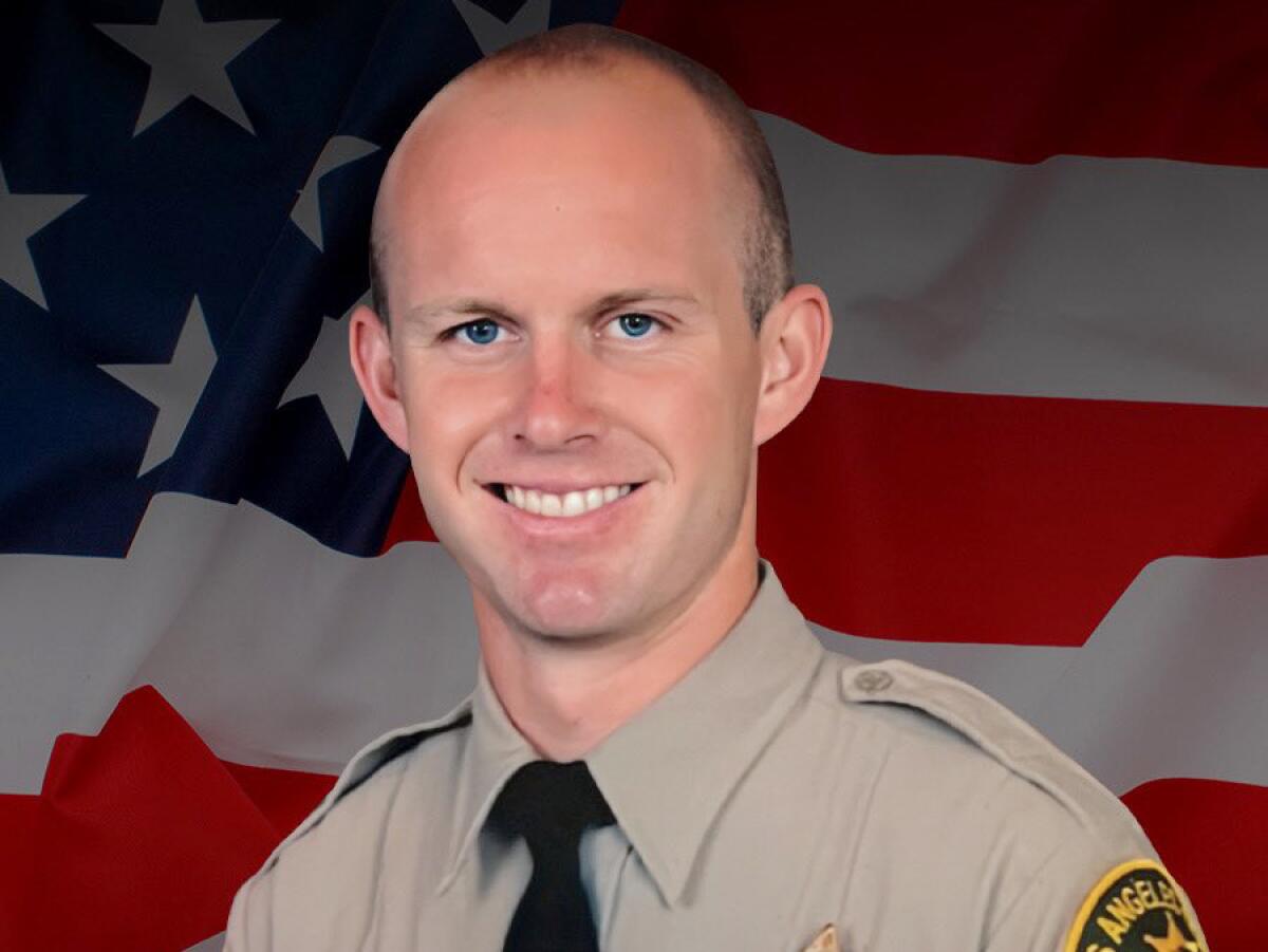 A portrait of a smiling young man in deputy's uniform.