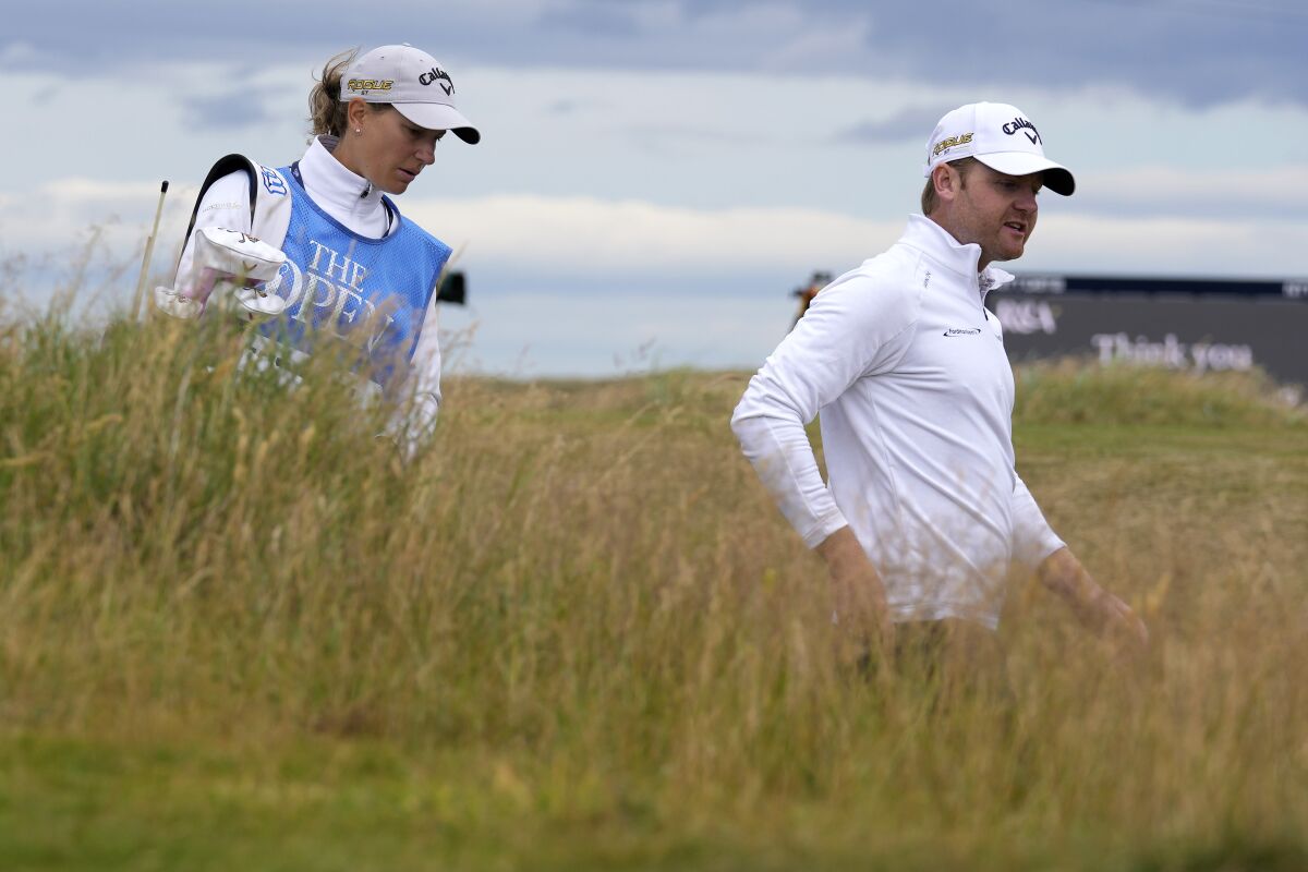 Alex Wrigley and Johanna Gustavsson walk the Old Course at St. Andrews during a practice round at the British Open.