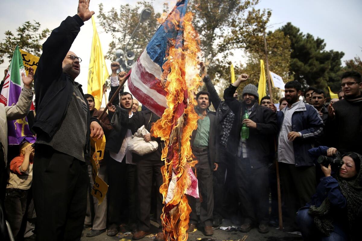 Protesters burn a U.S. flag during an anti-American rally in Tehran.