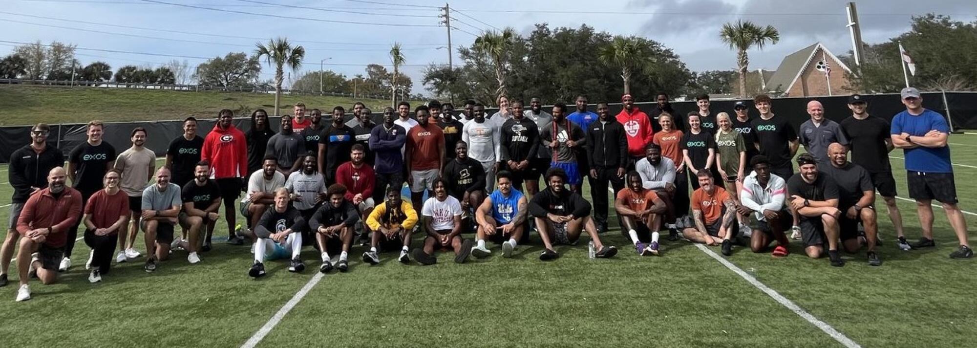 Former UCLA offensive lineman Atonio Mafiposes with people he met while training for the NFL draft