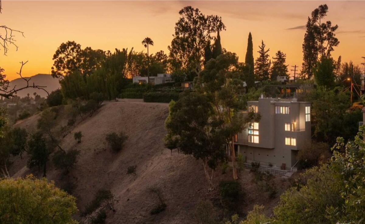 The three-story residence takes in city and canyon views from walls of glass and multiple decks.