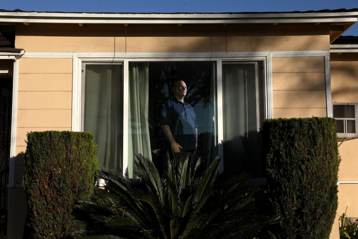 Matt Howard looks out the window of his home in Lakewood 