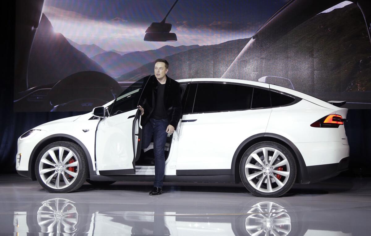 Elon Musk, CEO of Tesla Motors Inc., introduces the Model X car last year at the company's headquarters in Fremont, Calif.