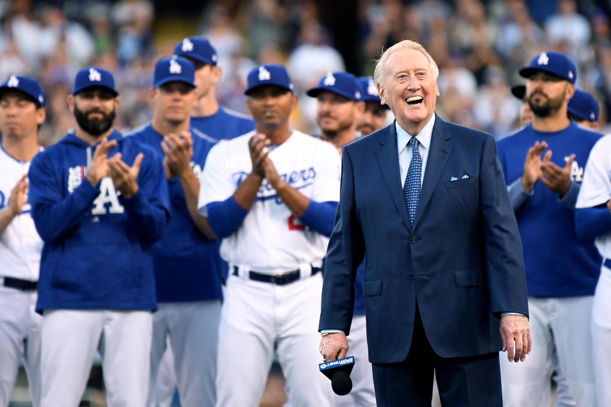 Dodgers broadcasting great Vin Scully smiles while being inducted into the Dodgers' Ring of Honor before a game.