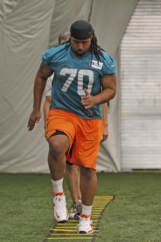 Dallas Thomas of the Miami Dolphins runs through drills during the rookie camp on May 3, 2013 at the Miami Dolphins training facility in Davie, Florida.
