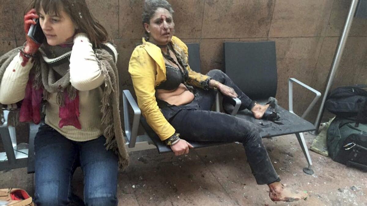Nidhi Chaphekar, a 40-year-old Jet Airways flight attendant from Mumbai, right, and an unidentified woman sit on chairs after being wounded in explosions at the airport in Brussels, Belgium.