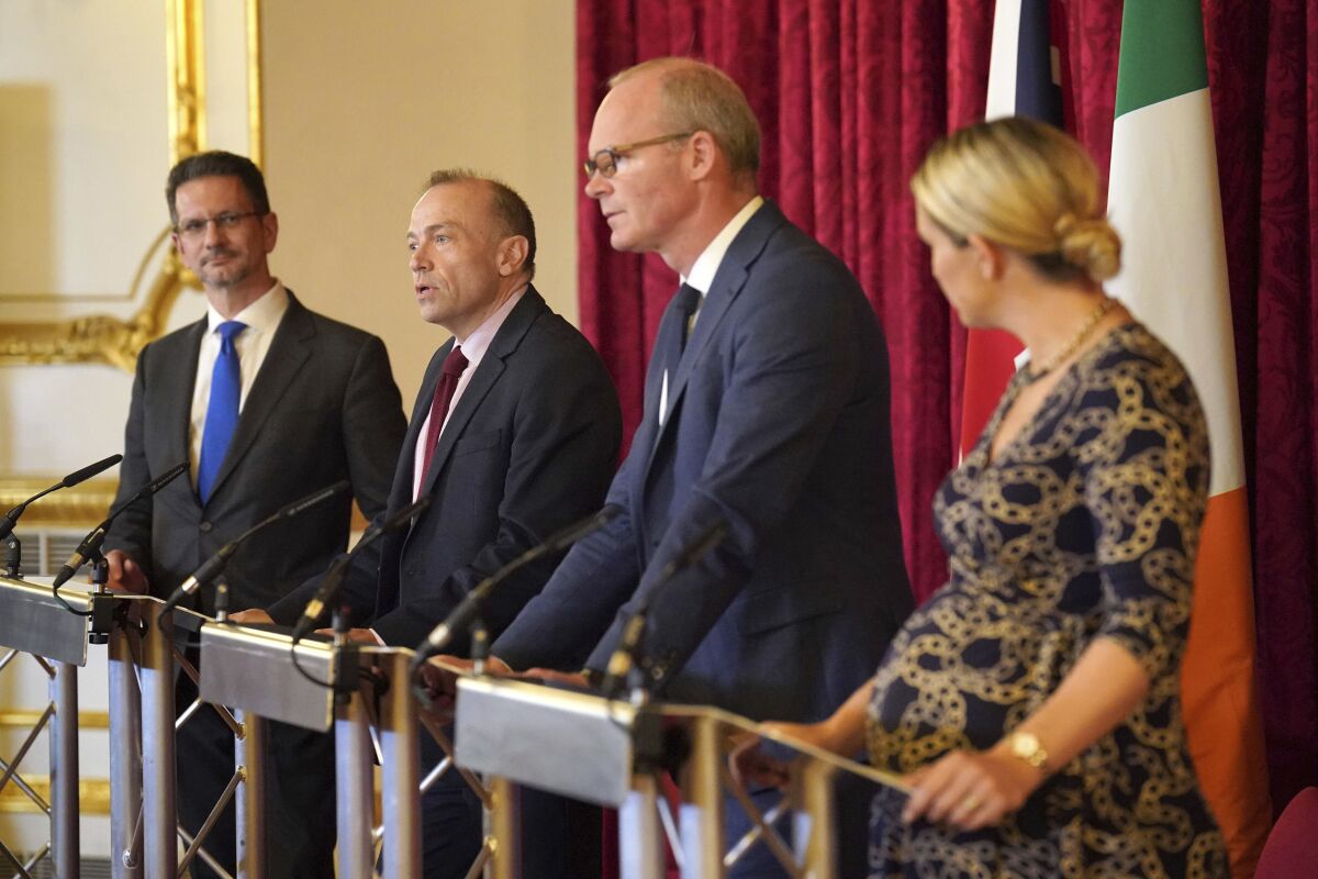 From left, Minister of State for Northern Ireland Steve Baker, the Secretary of State for Northern Ireland Chris Heaton Harris, Irish Foreign Affairs Minister Simon Coveney and Minister for Justice Helen McEntee speak during the British-Irish Intergovernmental Conference at Lancaster House in London, Friday Oct. 7, 2022. (Jonathan Brady/PA via AP)