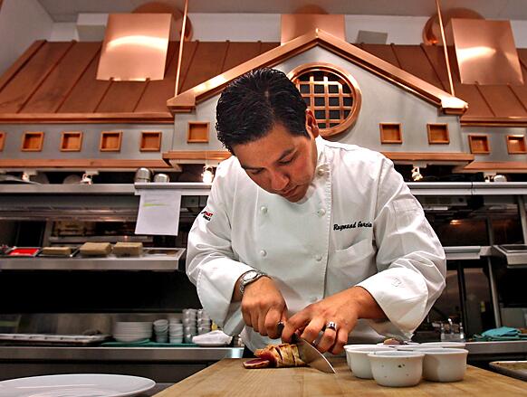 Chef Ray Garcia prepares a dish in the kitchen at Fig Restaurant at the Fairmont Miramar Hotel in Santa Monica.